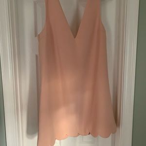 Tobi mini dress. Has scalloped hem and deep V back.
